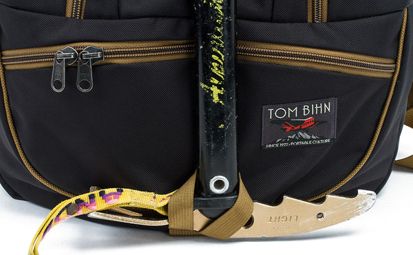 A close shot of an ice axe threaded through the ice axe loop on the face of the Guide's Edtiion Synapse 25.